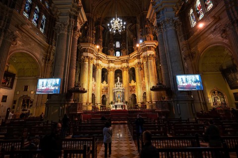 MALAGA, SPAIN - FEBRUARY 1, 2026: A wide interior panorama of Malaga Cathedral's nave and apse