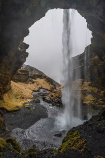 Waterfall from behind, lava rock canyon, winter, Kvernufoss, Skogar, Iceland, Scandinavia