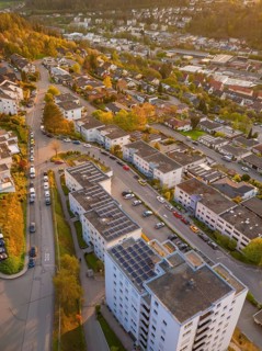Town view with numerous residential buildings and streets, in warm evening light, Nagold, Black