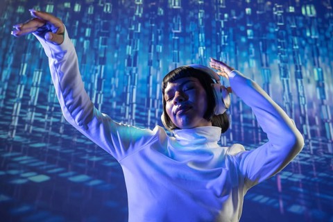 A futuristic Latin woman immersed in music, wearing headphones and dressed in a white turtleneck,