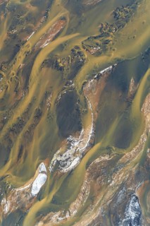 Aerial photograph showcasing Iceland's stunning river patterns. The natural textures and colors