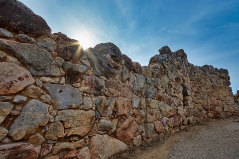 Old stone wall at sunrise creating a historic atmosphere, Tiryns, ancient city in Argolis,