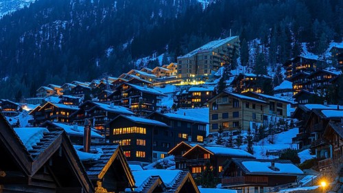 Snow-covered hotels and chalets built into the hillside, night view, Grimentz, Val d'Anniviers,