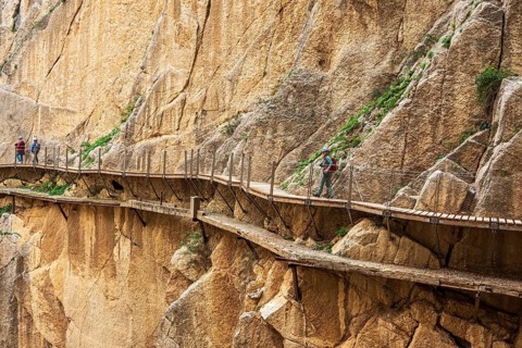 Tourists on the elevated path of the caminito del rey, along a deep gorge, Andalusia, Spain