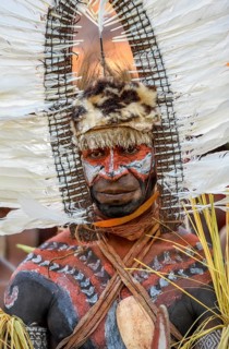 Portrait, warrior with feather decoration and body painting in the village of Upovia, Lake Murray,