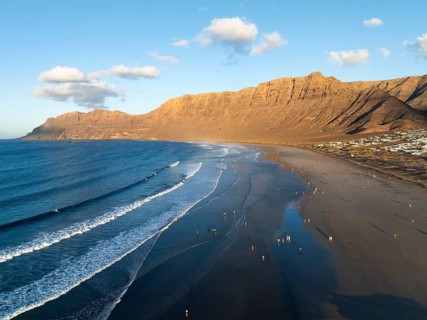 Risco de Famara cliffs and sea with Famara beach, in the evening light, Playa de Famara, aerial