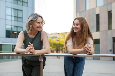 A joyful moment of a mom and daughter enjoying quality time together in a city setting, depicting
