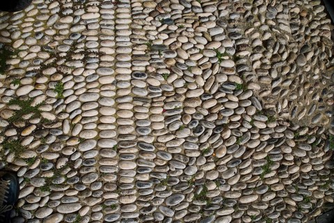 Non-uniform pattern of paving stones with moss and grey tones, Rhodes Old Town, Rhodes, Dodecanese,