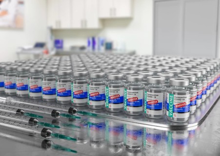 Hundreds of Coronavirus COVID-19 Vaccine Booster Vials and Syringes In Medical Office