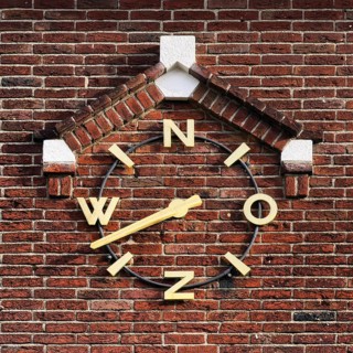 Wind clock on brick wall, Roermond, Limburg Province, Netherlands