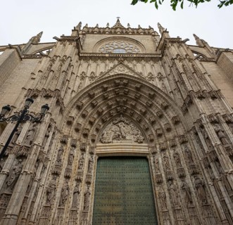 Impressive Gothic façade with detailed portal and richly decorated sculptures, Seville, Andalusia,