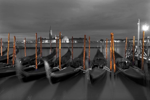 Nocturnal atmosphere with moving gondolas, San Georgio Maggiore in the back, Guidecca island on the