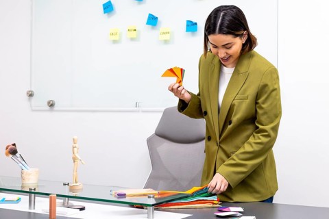 A professional image consultant examines color swatches during a session. Various shades are laid