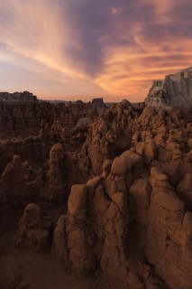 Breathtaking view of unique sandstone formations under a vibrant sunset sky at Goblin Valley State