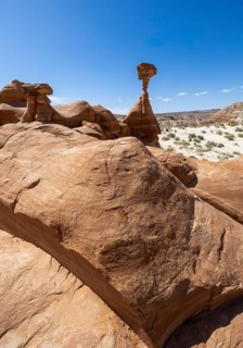 Discover the striking rock formations of Toadstool Hoodoos against a vivid blue sky, showcasing the