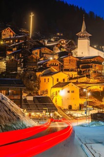 Braking track of a passing vehicle, old farmhouses and barn storage in the back, white cellars, the