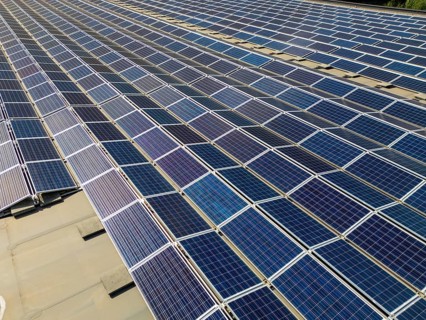 An aerial view of a solar panel array in Switzerland, showcasing the efficient use of renewable