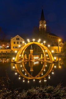Floating double candle arch from the Ore Mountains with model of the church on the village pond,