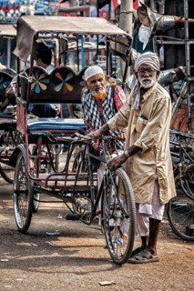 AGRA, INDIA, NOVEMBER 21, 2012: Bicycle rickshaws in the street of Agra, Uttrar Pradesh, India
