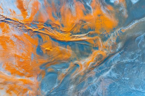 A mesmerizing aerial view of a natural landscape transformed into an abstract multicolour canvas,