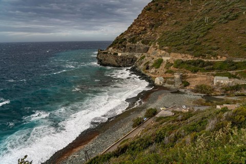 Beach and Genoese tower of La Marine de Negru on the west coast of Cap Corse, Corsica, France