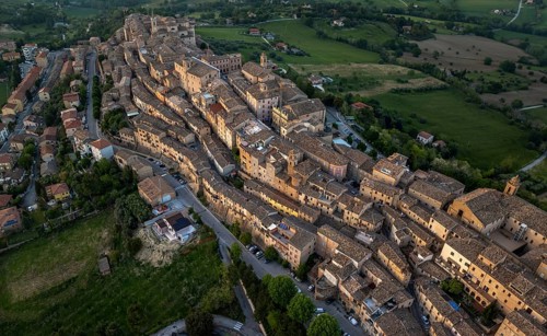 Aerial view of Treia, Italy, highlighting its remarkable medieval architecture nestled amid lush
