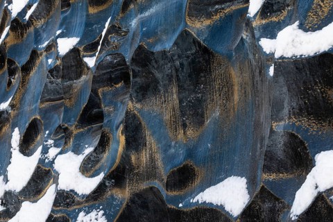 Structures in glacial ice, ice cave, glaciers, black glaciers reflecting sunlight, snow,