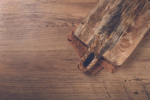 Square, chopping wooden board, chopping board with handle, on a kitchen towel, rustic style, top