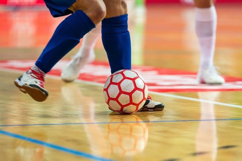 Detail of futsal ball and players legs in Lubin, Poland