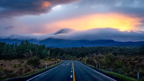 Mount Ngauruhoe in the morning at sunrise with glowing clouds, road SH 47. Tongariro National Park,