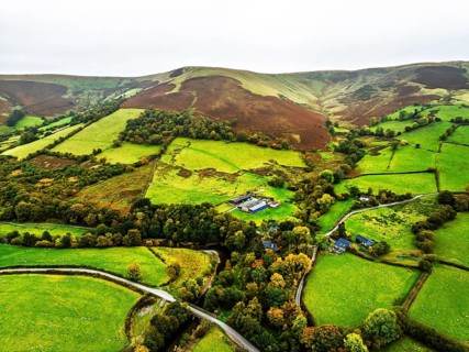 Autumn colours of Farms over River Wye and Road A470 from a drone, Llanidloes, Powys,
