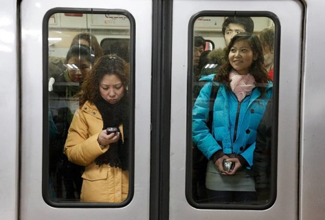 Beijing, CHN, 19.02.09 — Chinese passengers on a crowded subway in Beijing, CHINA