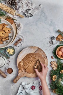 Top view of an anonymous woman preparing desserts for christmas at a table with christmas
