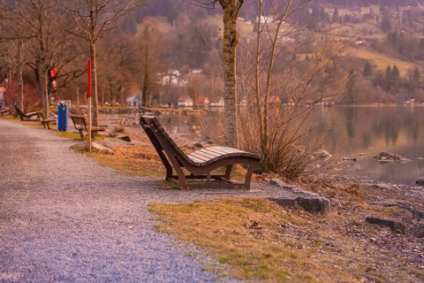 Several benches along a gravel path by the lake, quiet landscape at dusk, Großer Alpsee, Immenstadt