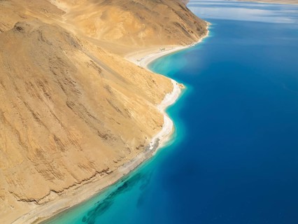 A breathtaking aerial view of Pangong Tso lake in Ladakh, India, showcasing its vibrant blue waters