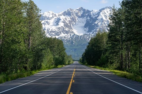Road through taiga and mountainous landscape, picturesque landscape on Richardson Highway, Alaska,