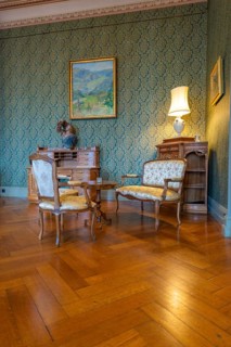 Elegant room with antique furniture, stylish wallpaper and soft lighting, Grandhotel Giessbach,