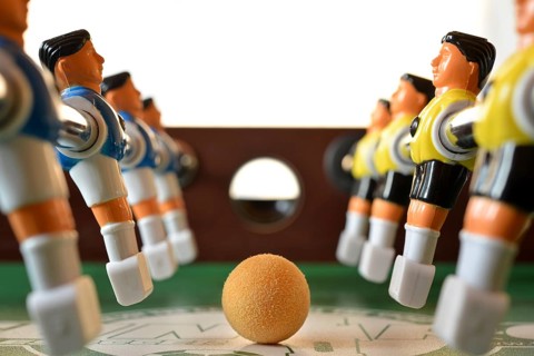 Foosball table close-up of the ball and players in Poland