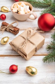Christmas or New Year composition. Decorations, box, red balls, cinnamon, fir and spruce branches,