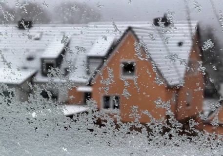 Sleet with ice on a window pane looking at a house in winter, Witten, North Rhine-Westphalia,