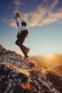 Trail running in autumn on the Jochberg on Lake Walchensee against the wonderful backdrop of the