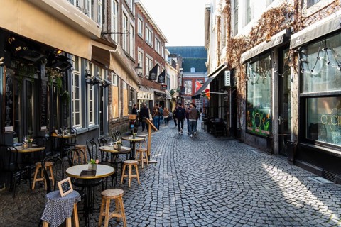Alley with cafes and shops in the old town of Maastricht, the Netherlands