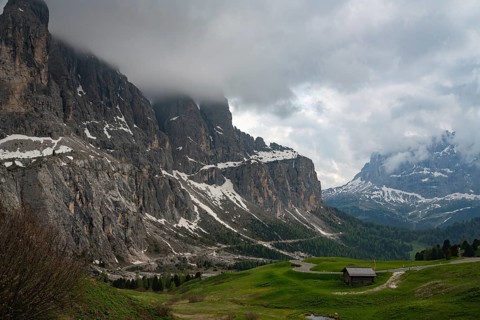 Majestic view of Val di Funes in the Dolomites, Italy, featuring rolling green hills, rugged
