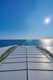 View from the ship's deck, Mein Schiff 6, of the vast sea under bright sunshine and blue skies,