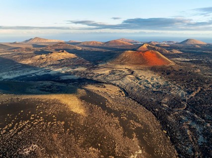 Picturesque volcanic landscape with volcanic craters and lava fields in morning light, Montaña