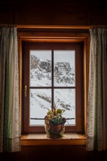 View from the window of a mountain hut, Schlüterhütte, Gampenwiese, Dolomites, snow, Puez-Geisler