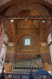 Magnificent interior with detailed patterns and calligraphy on ceilings and walls, tomb of the