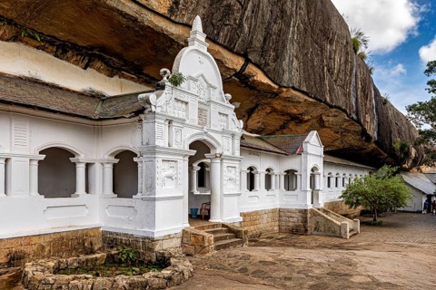White temple built into the rock, with decorations and historic ambiance, The cave temple of