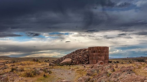 Historic stone structure against dramatically cloudy sky, The Chullpas of Sillustani near Puno in