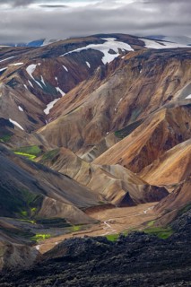 Small river between colourful rhyolite mountains, volcanic landscape, colourful erosion landscape,